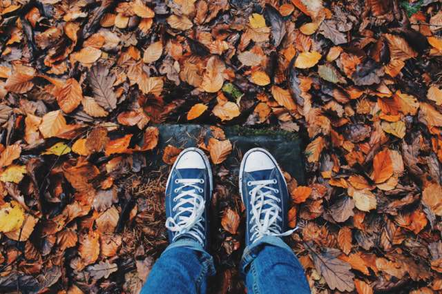 feet and autumn leaves