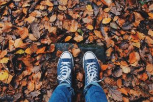 feet and autumn leaves