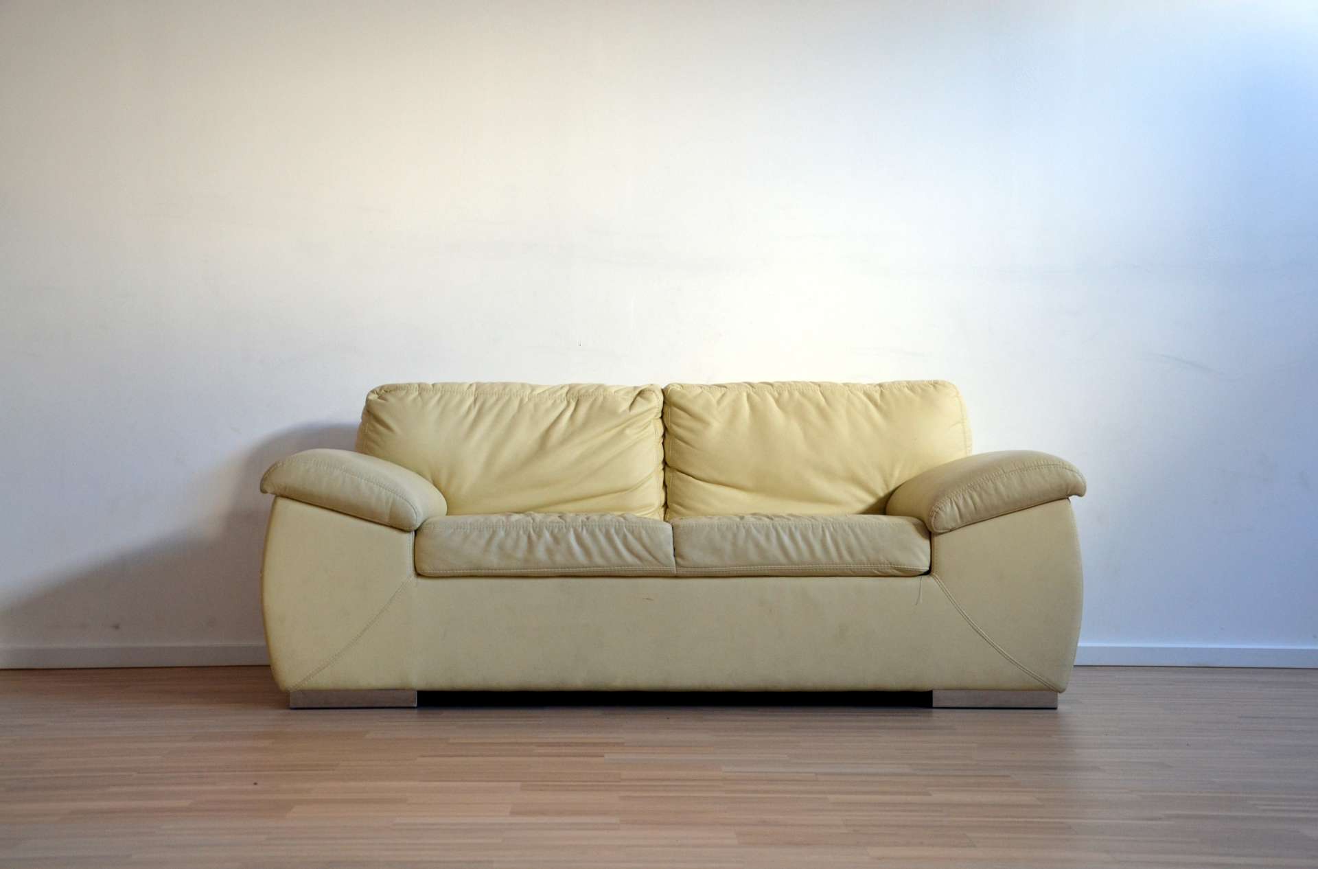 yellow leather used sofa in an empty room