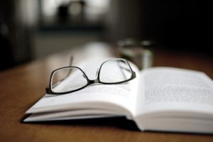pair of glasses on book