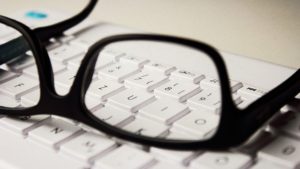 pair of glasses on keyboard